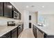 Modern kitchen features dark cabinetry, granite countertops, and stainless steel appliances at 641 W Freedom St, Florence, AZ 85132