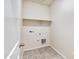 Laundry room with tile flooring and shelving at 641 W Freedom St, Florence, AZ 85132