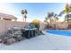 Outdoor kitchen with built-in grill and stone accents at 6540 W Dublin Ct, Chandler, AZ 85226