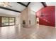 Bright living room features a fireplace and sliding glass doors to the backyard at 7319 E Rose Ln, Scottsdale, AZ 85250