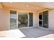 Covered patio with views of the house interior and a vacant backyard with block fencing at 7662 W Rowel Rd, Peoria, AZ 85383