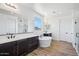 Luxurious primary bathroom with double vanities, soaking tub, and a walk-in shower at 7662 W Rowel Rd, Peoria, AZ 85383