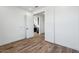Bedroom featuring wood-look floors, white walls, and paneled doors at 7662 W Rowel Rd, Peoria, AZ 85383