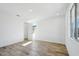 Sun-drenched bedroom with wood-look floors and a large window at 7662 W Rowel Rd, Peoria, AZ 85383