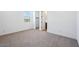 Neutral carpeted bedroom with white walls, trim and doors provides a bright living space at 7662 W Rowel Rd, Peoria, AZ 85383