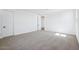 Large bedroom with carpet flooring and white walls, featuring multiple doors at 7662 W Rowel Rd, Peoria, AZ 85383