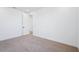 Spacious carpeted bedroom boasts white walls, trim and doors and a walk-in closet at 7662 W Rowel Rd, Peoria, AZ 85383