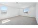 Spacious bedroom with carpet flooring and large windows providing natural light at 7662 W Rowel Rd, Peoria, AZ 85383