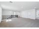 Spacious bonus room includes carpeted floors, neutral walls, and white doors at 7662 W Rowel Rd, Peoria, AZ 85383