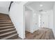 Entryway with staircase, wood-look floors, and white paneled doors at 7662 W Rowel Rd, Peoria, AZ 85383