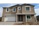 Two-story house with a neutral color scheme and a white door at 7662 W Rowel Rd, Peoria, AZ 85383