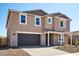 Delightful two-story home with a garage, a landscaped front yard, and great curb appeal at 7662 W Rowel Rd, Peoria, AZ 85383