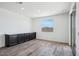 Bright flex room with wood-look floors, recessed lighting, window, and a long built-in counter and cabinets at 7662 W Rowel Rd, Peoria, AZ 85383