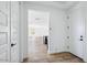 Bright foyer leading into an open floor plan with wood-look tile flooring at 7662 W Rowel Rd, Peoria, AZ 85383