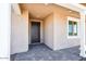 Covered front porch with stone flooring and a classic front door, offers a welcoming entrance at 7662 W Rowel Rd, Peoria, AZ 85383