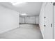 View of a 2-car garage with a garage door that's been left partially open at 7662 W Rowel Rd, Peoria, AZ 85383