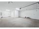 View of a spacious three car garage featuring painted floors and ample lighting at 7662 W Rowel Rd, Peoria, AZ 85383
