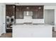 Kitchen with stainless steel appliances, modern cabinetry, an island with white countertops and tile flooring at 7662 W Rowel Rd, Peoria, AZ 85383