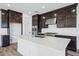 Kitchen featuring a large island with white countertops, stainless steel appliances and dark cabinets at 7662 W Rowel Rd, Peoria, AZ 85383