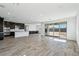 Spacious living area with dark cabinetry, stainless steel appliances, and sliding glass doors at 7662 W Rowel Rd, Peoria, AZ 85383