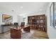 Bright home office featuring a desk, bookshelves, and a large window at 7662 W Rowel Rd, Peoria, AZ 85383