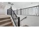 Staircase with carpeted steps and black metal railing at 7662 W Rowel Rd, Peoria, AZ 85383