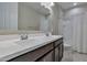 Bathroom boasts double sinks, a shower/tub combo and stylish dark brown vanity at 8026 W Wood Ln, Phoenix, AZ 85043