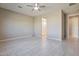 Spacious bedroom with ceiling fan and access to the bathroom at 8026 W Wood Ln, Phoenix, AZ 85043