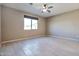 Well-lit bedroom with ceiling fan and window coverings at 8026 W Wood Ln, Phoenix, AZ 85043