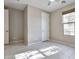 Bright bedroom with tile floors and spacious closet at 8026 W Wood Ln, Phoenix, AZ 85043