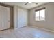 Well-lit bedroom featuring tile floors and a large closet at 8026 W Wood Ln, Phoenix, AZ 85043