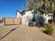 House exterior showcasing a wooden gate and rock landscaping at 8026 W Wood Ln, Phoenix, AZ 85043