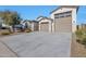Two-car garage with large driveway and decorative landscaping at 8026 W Wood Ln, Phoenix, AZ 85043