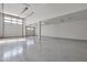 Spacious two-car garage with high ceilings and epoxy flooring at 8026 W Wood Ln, Phoenix, AZ 85043