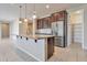 Modern kitchen with island, pantry, and stainless steel appliances at 8026 W Wood Ln, Phoenix, AZ 85043