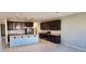 Modern kitchen with granite countertops and dark wood cabinets at 8026 W Wood Ln, Phoenix, AZ 85043