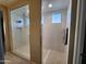 Large walk-in shower with glass enclosure and multiple shower heads at 8026 W Wood Ln, Phoenix, AZ 85043