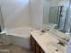 Bright bathroom featuring a soaking tub, tiled floors, and double sinks at 9065 E Gary Rd # 124, Scottsdale, AZ 85260