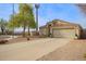 One-story house with tan exterior, two-car garage, and desert landscaping at 948 N 90Th Cir, Mesa, AZ 85207