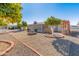Landscaped backyard with mature citrus trees and gravel at 9814 W Cedar Dr, Sun City, AZ 85351