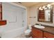 Clean bathroom with tub, toilet and granite vanity at 9814 W Cedar Dr, Sun City, AZ 85351
