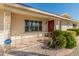 Front porch with red door and decorative railing at 9814 W Cedar Dr, Sun City, AZ 85351