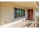 Front entry with red door, window and stone flooring at 9814 W Cedar Dr, Sun City, AZ 85351