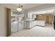 Kitchen with ample cabinetry and patio access at 9814 W Cedar Dr, Sun City, AZ 85351