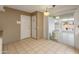 Kitchen with door leading to a sunroom and backyard access at 9814 W Cedar Dr, Sun City, AZ 85351