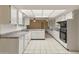 Bright eat-in kitchen with ample cabinetry and tile flooring at 9814 W Cedar Dr, Sun City, AZ 85351