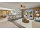 Open living room features a kitchen with breakfast bar and access to a patio at 9814 W Cedar Dr, Sun City, AZ 85351
