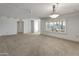 Bright living room with large window and carpet flooring at 9814 W Cedar Dr, Sun City, AZ 85351