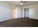 Bedroom with carpet, door to bathroom and large closet at 10976 W Coggins Dr, Sun City, AZ 85351