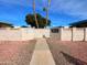 Community entrance of Holly Court, showing walkway and building exterior at 10976 W Coggins Dr, Sun City, AZ 85351